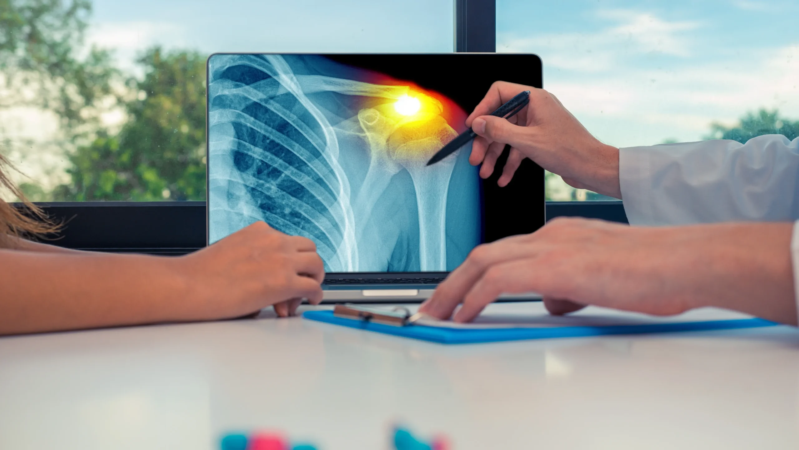 A doctor evaluates a patient's shoulder, focusing on prehabilitation benefits like mobility, strength, and pain relief before surgery.