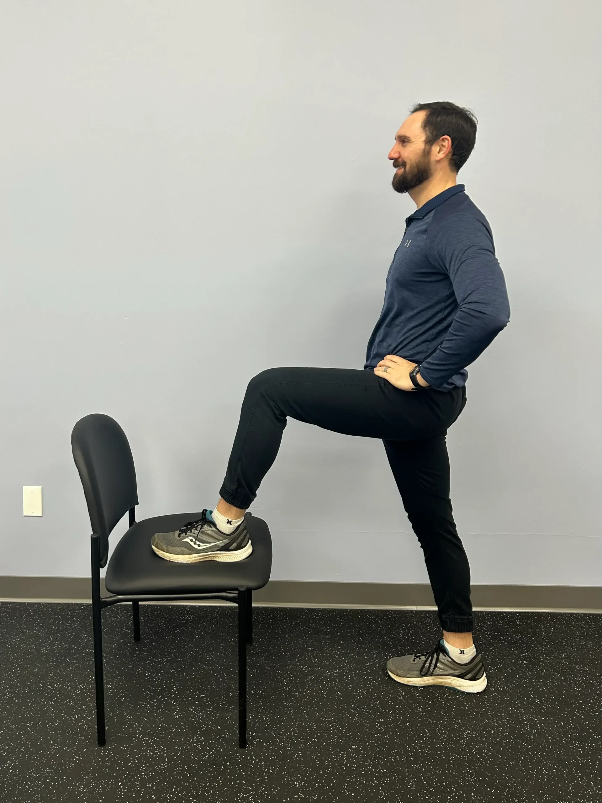 Man demonstrating Hip Flexor Stretch with chair.