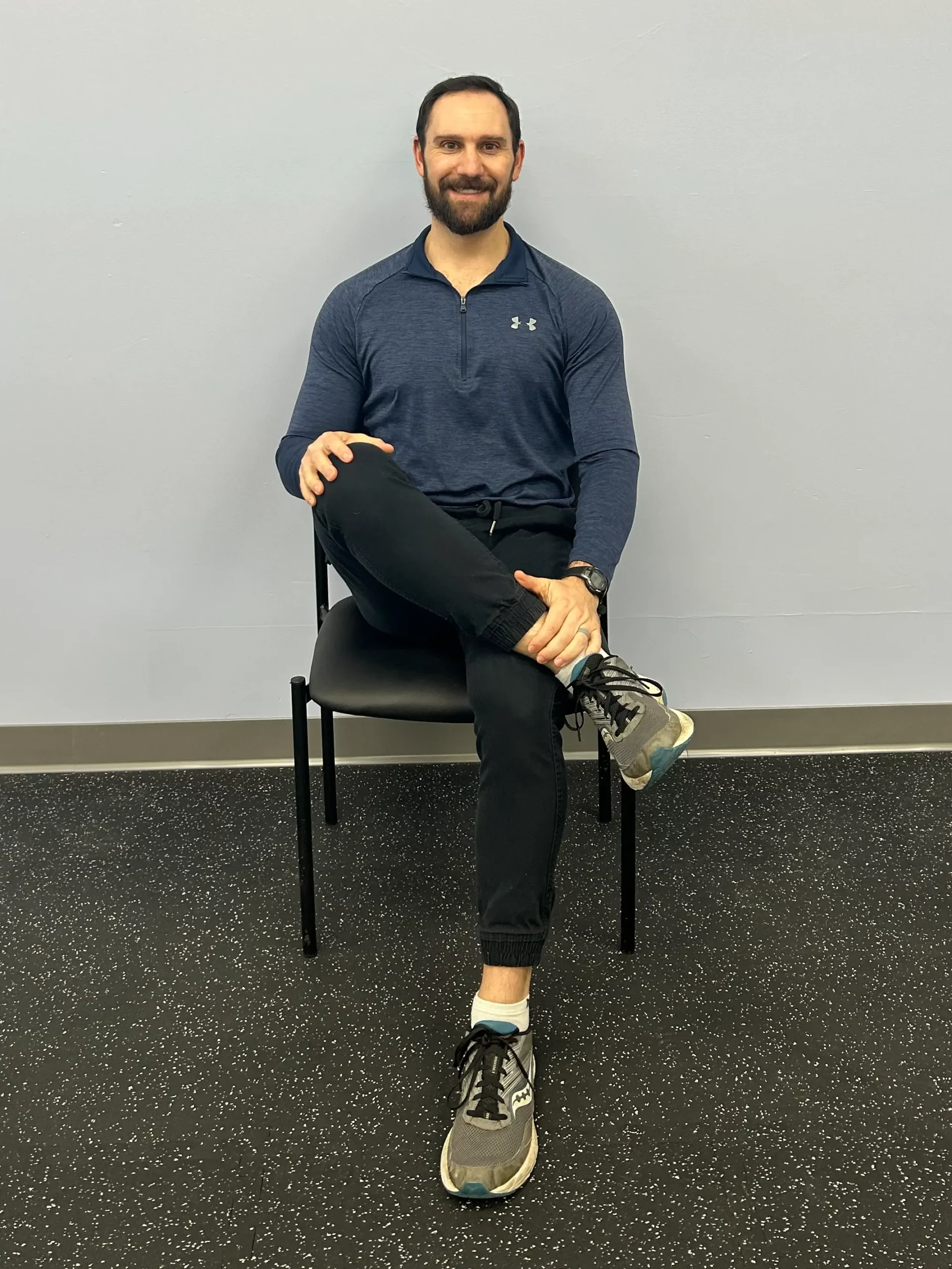 Man demonstrating Seated PIRIFORMIS/FIGURE 4 STRETCH for hip.
