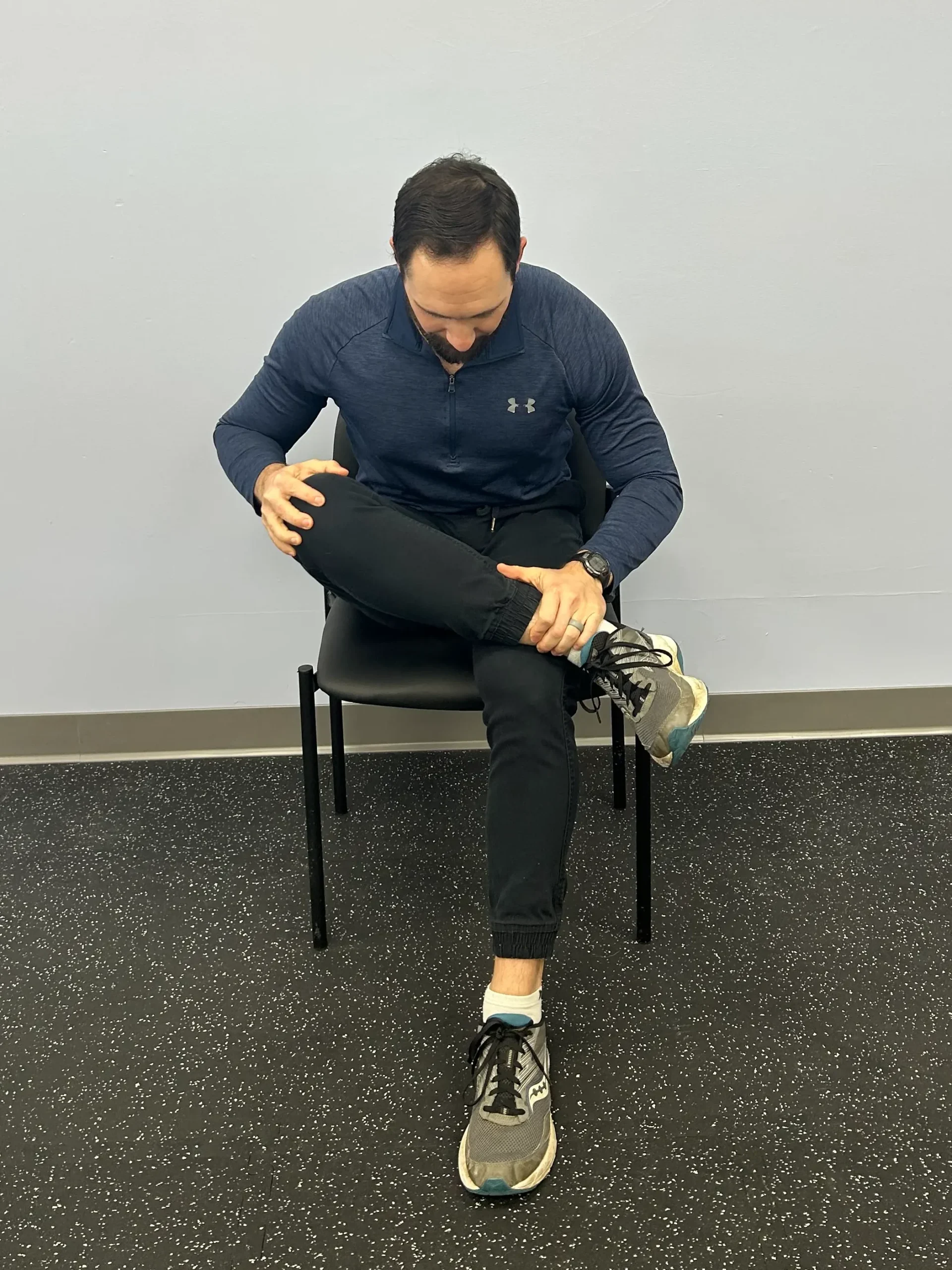 Man demonstrating Seated PIRIFORMIS/FIGURE 4 STRETCH for hip.