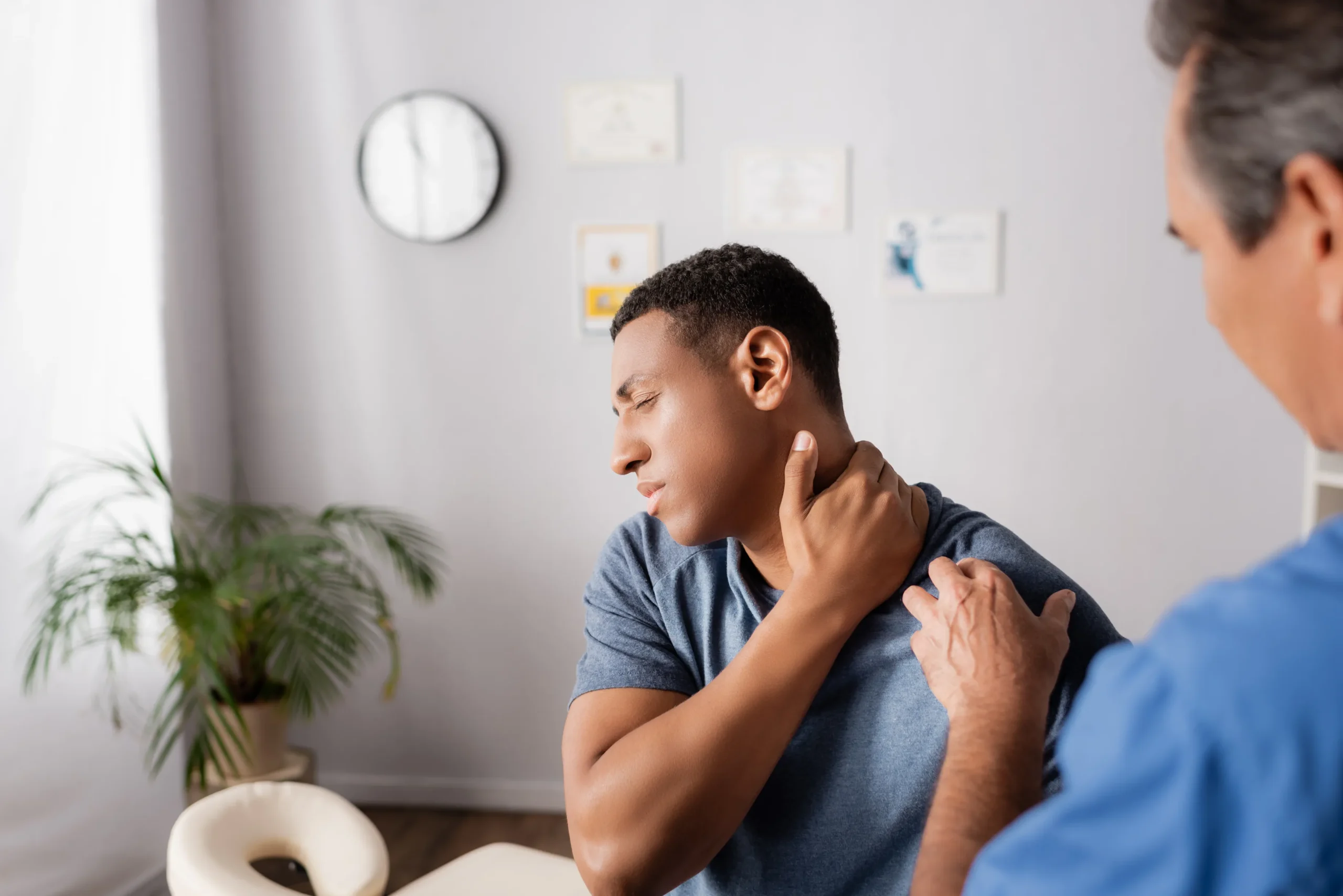 Physical Therapist giving care to a patient's neck pain.