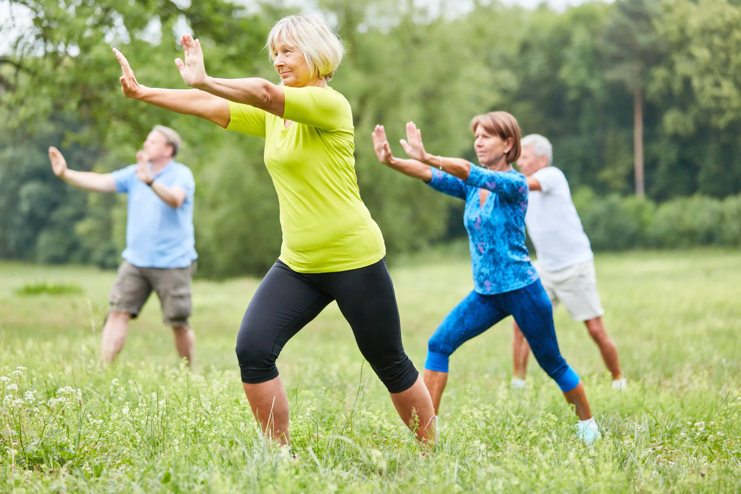 2 men and 2 women practicing Tai Chi together emphasizing that motion is medicine.