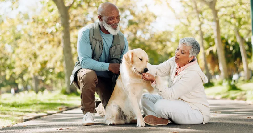 Elderly couple with dog outdoors